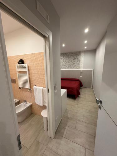 a small bathroom with a red bed and a sink at Rooms Sorrento in Sorrento