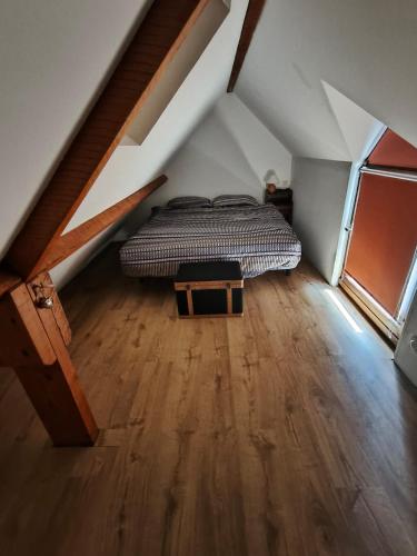 a bedroom with a bed in a attic at Gîte - La Gariotte du Causse in Frayssinet