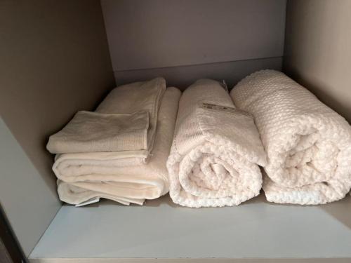 a group of towels are sitting on a shelf at Excutive suites in Kyebando
