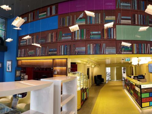 a library with a large wall of books at ibis Styles Ankara in Ankara