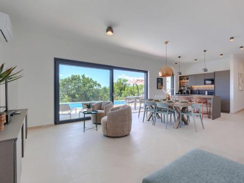 an open living room with a dining room and a kitchen at Villa Florinda by Interhome in Raša