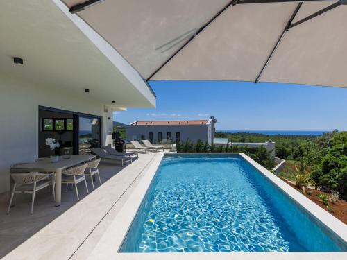 a swimming pool in the backyard of a house at Villa Florinda by Interhome in Raša