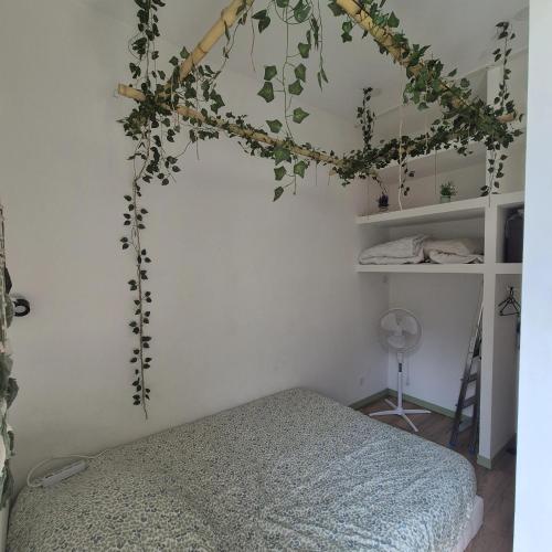 a bedroom with a bed and ivy on the wall at Appartement Jungle 4 places in Saint-Étienne