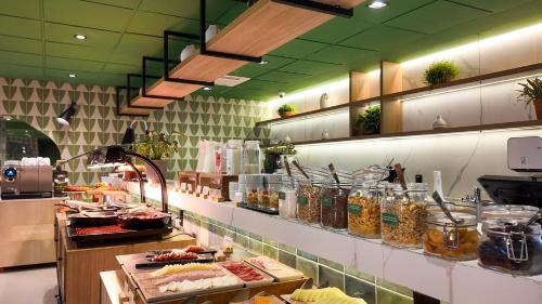 a kitchen with a bunch of food on a counter at Grand Mercure SP Pinheiros in São Paulo