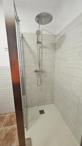 a shower with a shower head in a bathroom at Villa Amistad in Orba