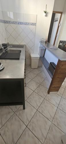 a kitchen with a sink and a toilet at Les Gites D'Angres in Angres