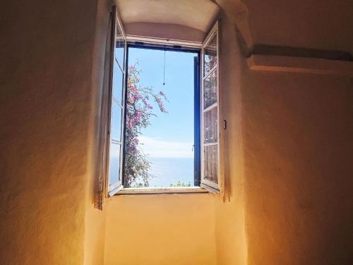 an open window with a view of the ocean at Apartment Risorgimento Apartment by Interhome in Cipressa