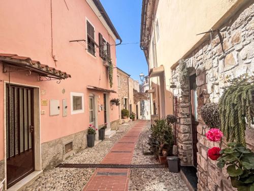 an alley in an old town with pink buildings at Apartment Risorgimento Apartment by Interhome in Cipressa