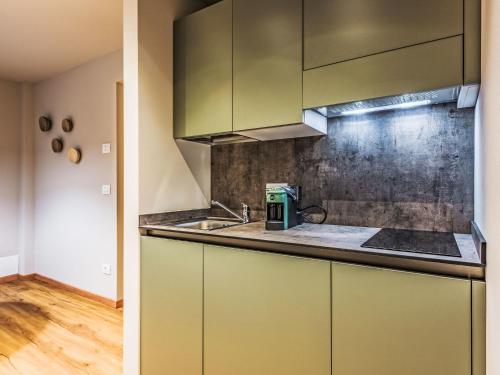 a kitchen with green cabinets and a sink at Apartment La Spada by Interhome in Ossana