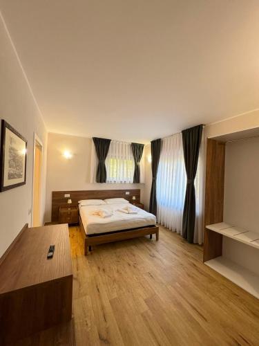 a bedroom with a bed and a table in it at Villa Seli in Dogliani