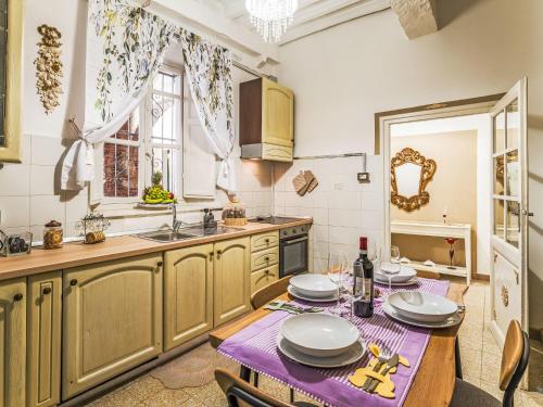 a kitchen with a table and a sink at Apartment Nido nel centro by Interhome in Camaiore