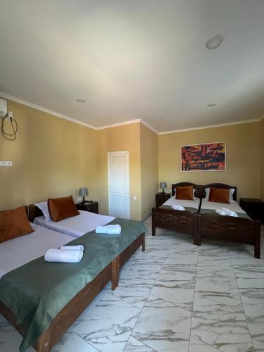 a room with two beds in a room with at Cottage Shara - შარა in Ureki