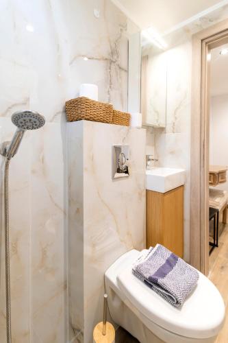 a bathroom with a shower and a toilet and a sink at Louis House in Rhodes Town