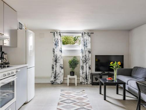 a living room with a couch and a tv at Apartment Odal by Interhome in Halmstad