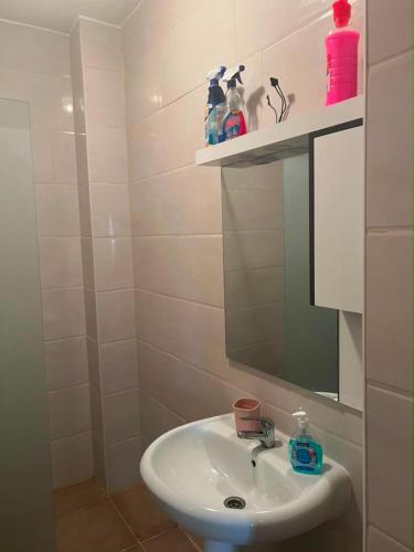 a bathroom with a sink and a mirror at Aparts 3 F3 BEJAIA VACANCE in Bejaïa