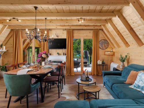 a dining room with a table and a blue couch at Chalet Ivica by Interhome in Sveti Rok