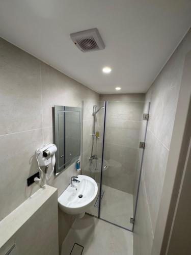 ein Badezimmer mit Waschbecken und Dusche in der Unterkunft Arab Tower Hotel in Amman