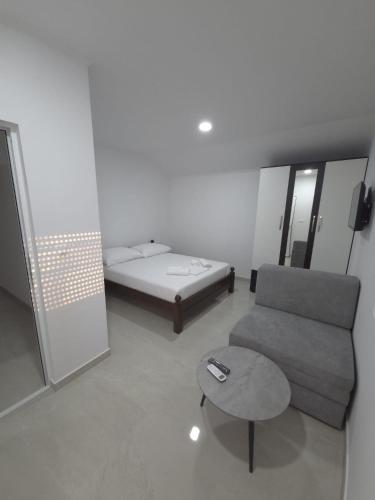 a living room with a couch and a bed at Villa Jopi in Neum