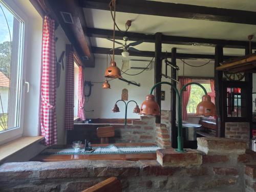 a kitchen with a sink and a brick fireplace at Apartmaji Picasso Design in Veržej