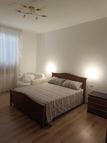 a white bedroom with a bed and a couch at B&B Residenza Gigina in Sezze