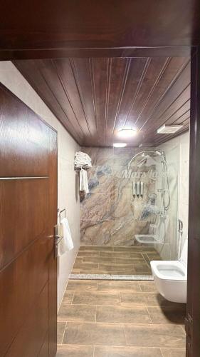 a bathroom with a shower and a sink at Wadi Rum Bella Rose Luxury Camp in Disah