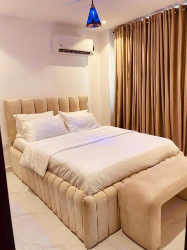 a bedroom with a large bed in a room at Eminoky Apartment in Lagos