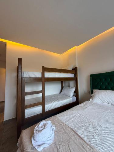 a bedroom with two bunk beds and a bed at Hotel Omega in Oiapoque