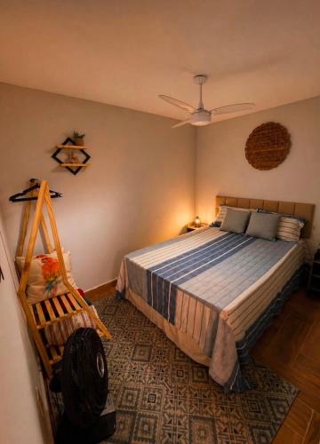 a bedroom with a bed and a ceiling fan at CasaMare in Cariacica