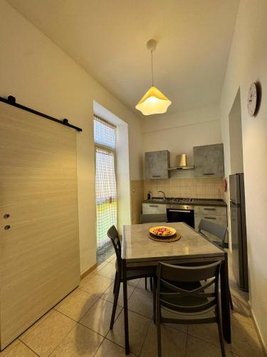 a kitchen with a table with a pizza on it at Hour Home in Iglesias