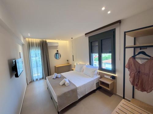 a bedroom with a bed and a large window at Elia Stay in Kalives Poligirou