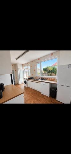 a large kitchen with a large window in a room at Riverside all for you in Kingston upon Thames