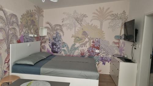 a bedroom with a bed with a floral wallpaper at Peaceful Cherry Place in Portorož