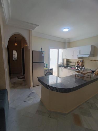 a kitchen with a large island in the middle at Dar hicham in Hajreien