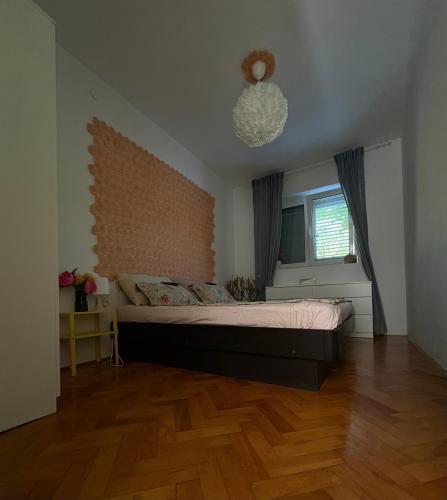 a bedroom with a large bed and a window at Apartment Rose in Portorož