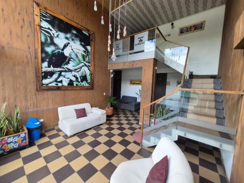 a lobby with a staircase and a living room at Hotel La Mansión in La Pintada