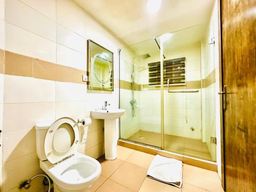 a bathroom with a toilet and a sink and a shower at Presken Hotel Fajodd-4, Allen, Ikeja, Lagos in Ikeja