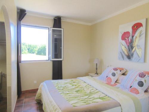 a bedroom with a large bed and a window at U Closu San Petru in Linguizzetta