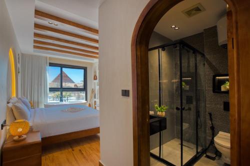 a bedroom with a bed and a glass shower at PANORAMA view pyramids in Cairo