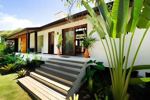 a house with a staircase leading to the front yard at Casas Versos do Mar in Marau