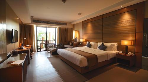 a hotel room with a large bed and a balcony at Hotel Luxury Villa - Near IGI Airport Mahipalpur New Delhi in New Delhi
