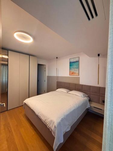 a bedroom with a large bed in a room at VOGH Olimp Premium Sea View Escape in Olimp