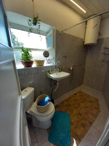 a bathroom with a toilet and a sink and a window at Belvedere di Van D'oro 1886 in Peroulades