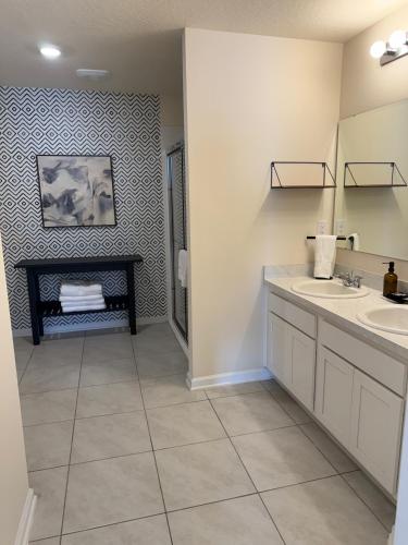 a bathroom with two sinks and a fireplace at Rybark Manor in Palm Coast