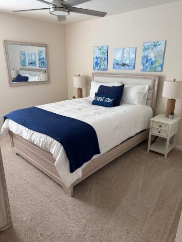 a bedroom with a large bed with a blue blanket at Rybark Manor in Palm Coast