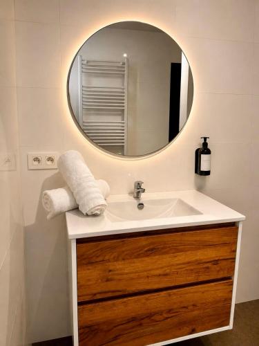 a bathroom with a sink and a mirror at Charleroi Brussels Airport White Castle in Charleroi