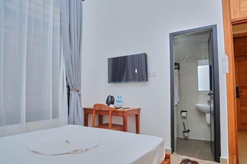 a bedroom with a bed and a sink and a mirror at Villa Maisha in Arusha