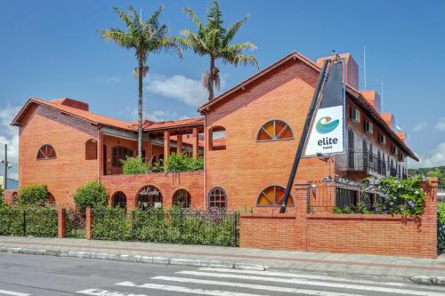 a brick building with a sign in front of it at Elite Hotel in Florianópolis