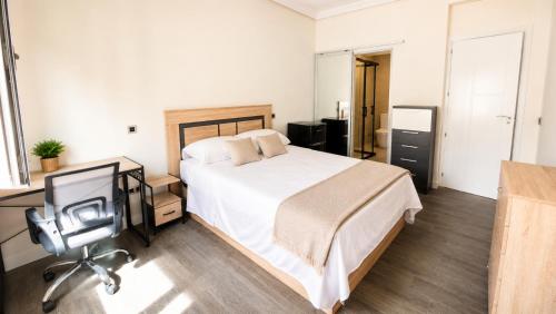 a bedroom with a bed and a television in it at ELAN LEVEL Parla in Parla