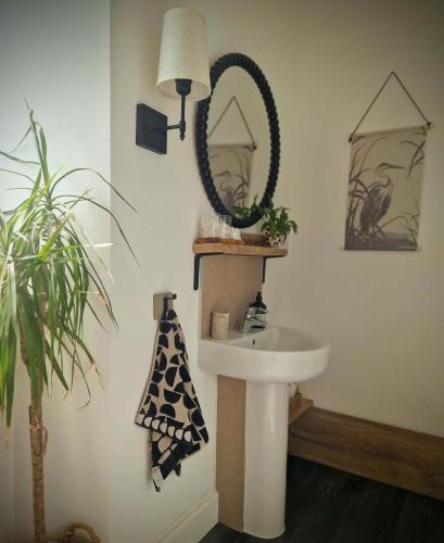 a bathroom with a sink and a mirror at Stone Cottage Relax & Unwind, Cosy Cinema Retreat in Laurencekirk