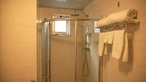 a shower in a bathroom with a glass shower stall at Amdina Hotel in Mekʼelē